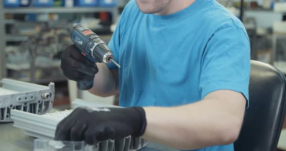 Worker testing LED lamp in an advanced electronics manufacturing facility