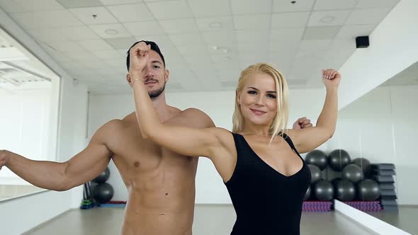 Couple Man and Woman Possing on the Camera on the Studio Background