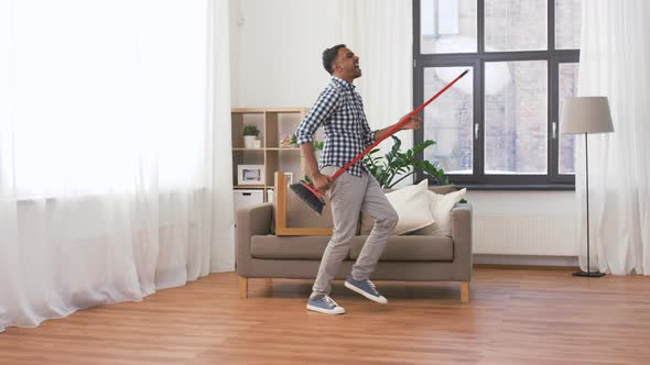 Man with Broom Cleaning and Having Fun at Home 49