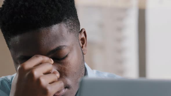 Close Up Exhausted Young Millennial African Businessman Overworked Man Massaging Dry Irritable Eyes