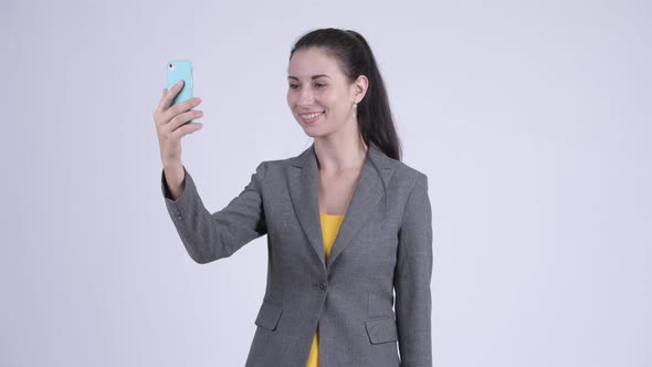 Happy Young Beautiful Businesswoman Video Calling with Phone