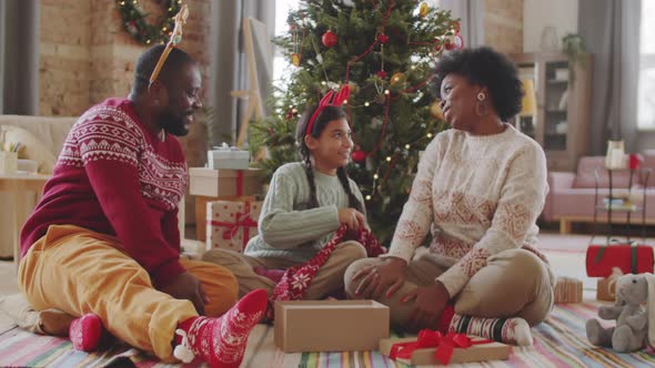 Happy Afro Family Sharing Christmas Presents at Home