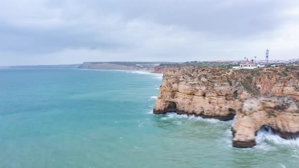 Aerial Drone Hyper Lapse Circling Around Beautiful Lagos Algarve Coastline with Waves Crashing