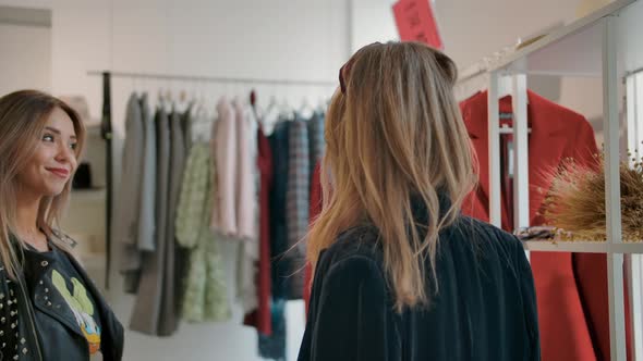 Young Woman Shopping with Friend During Sale