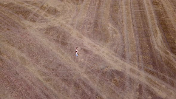 Aerial view two girls walking in the country at sunset