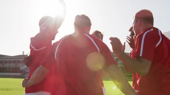 Team of male rugby players forming huddles in the rugby ground 4k