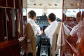 Pilots Operating Controls Of Private Jet - PhotoDune Item for Sale