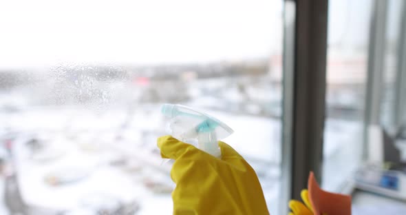 Woman Washes a Window in Rubber Gloves Closeup