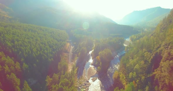 Low Altitude Flight Over Fresh Fast Mountain River with Rocks at Sunny Summer Morning.