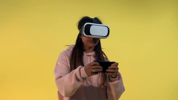 Multiracial Girl in Virtual Reality Glasses Playing Online Games on Smartphone