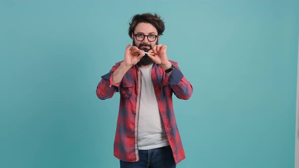 Young Man Who Is Addicted To Smoking, Breaks in Two a Cigarette.