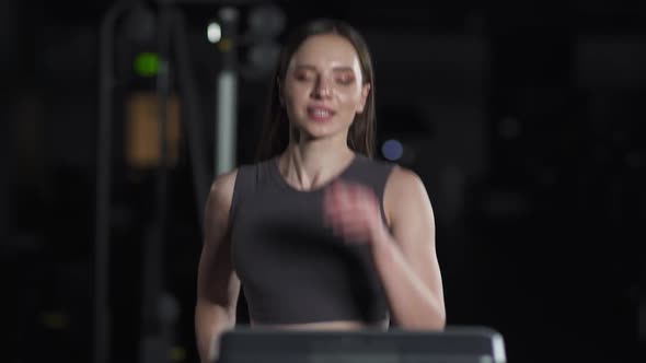 Portrait Young Female Athlete Run on a Treadmill Aerobic Exercise and Endurance Training a Runner