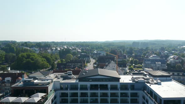 Aerial Drone Flying Forward Above Resort Hotel and Houses Buildings Streets in Scharbeutz Germany