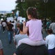Daughter with father on political rally riot. Girls sits on parents shoulders. - VideoHive Item for Sale