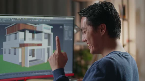 Asian Male Engineer Thinking Then Raising Index Finger While Designing House On A Desktop At Home