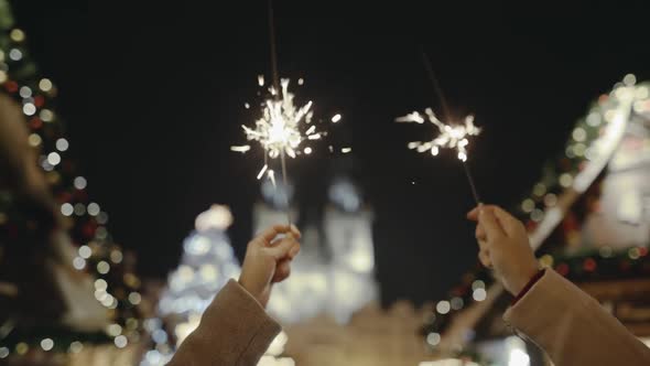 In the Foreground Tender Female Hands with Brightly Burning Bengal Lights