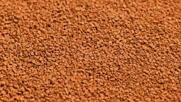 Full Frame Slowly Spinning Background of Freezedried Instant Coffee Granules Extreme Closeup with