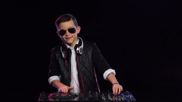 Boy Dj in Glasses Playing Music. Black Background, Slow Motion