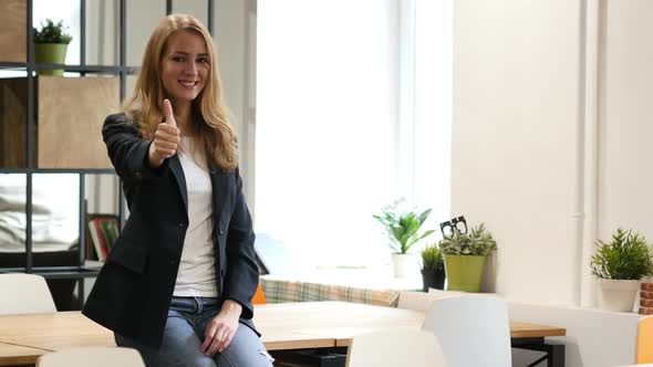 Thumbs Up, Successful Business woman Sitting on Desk in Office