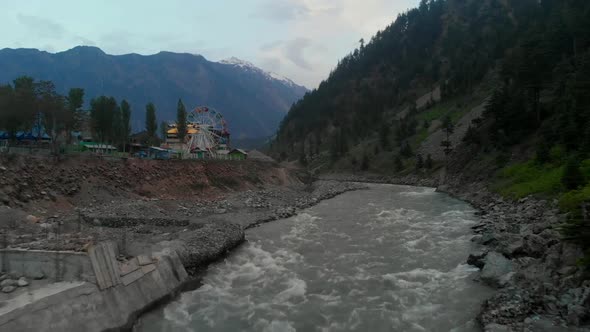 Aerial Over Swat River With Ferris Wheel In Background In Kalam, Pakistan. Dolly Forward