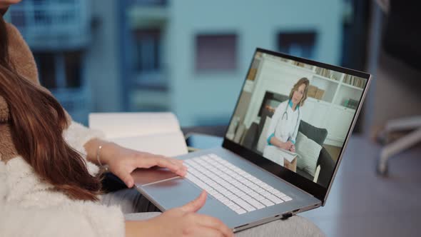 Computer Screen with Pleasant Woman Doctor Wearing White Coat Consulting Female Patient Online