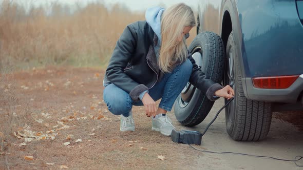 Woman Check Car Tire Pressure. Vehicle Trouble On Road On Vacation Trip. Female Trying Fix Car Tire.