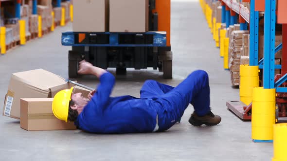 Male warehouse worker falling while working