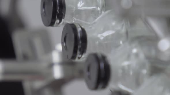 Vertical Video Glass Bottles Filled and Sealed with Rubber Caps on a Medical Solution Conveyor Line