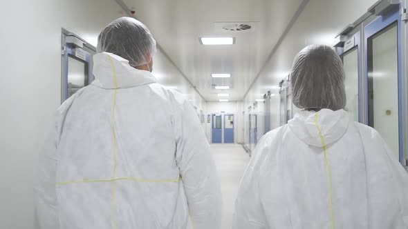American Man and Woman Worker Walk and Having Talk in Pharmaceutical Plant