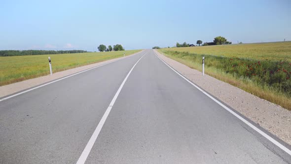 Asphalt road between agricultural fields of Latvia