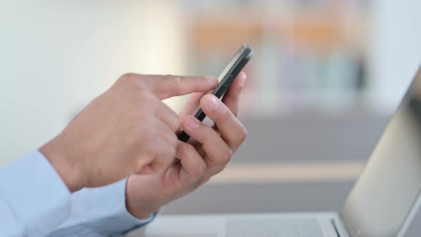 African Man Hands Typing on Smartphone Close Up