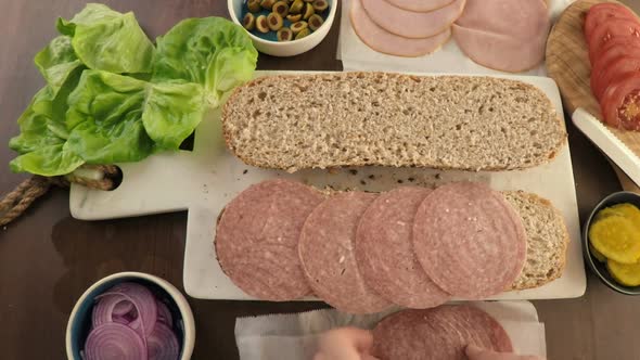 Time-lapse. Making fresh sub sandwich on multigrain bread.