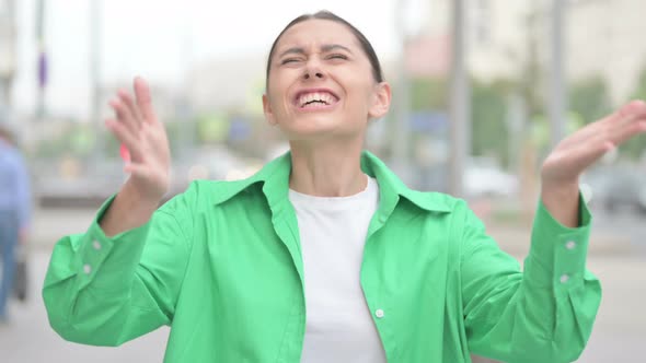 Angry Hispanic Woman Screaming in Frustration Outdoor