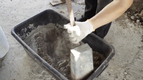 Male Worker Builder Guest Worker Mixes Cement Mortar