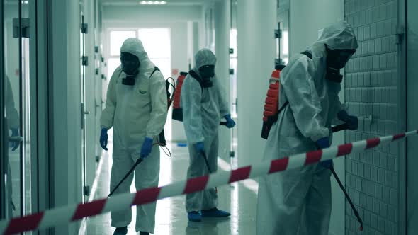 Three Workers Disinfect Corridor To Get Rid of Viruses