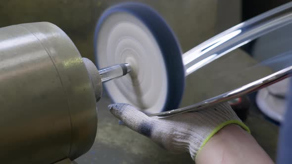 A Worker Polishes the Finished Silver Plate with a Machinetool at the Plant for Production Items of