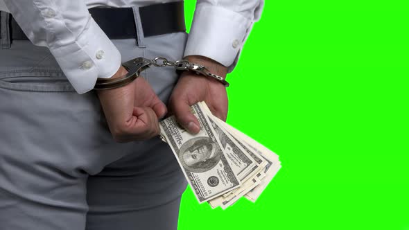 Man in Handcuffs Holding Money Back View