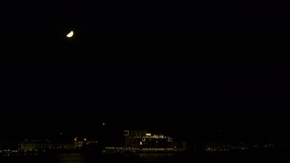 Moonset Behind a City 