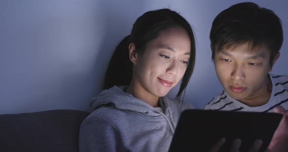 Couple Watching on Tablet Computer at Home