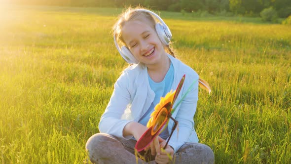 Positive Teenage Girl Listening to Music Via Headphones and Having Fun