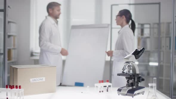 Biochemists Shaking Hands after Successfully Finishing Vaccine