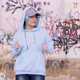 Blue haired teenage girl in light blue hoodie dancing against graffiti wall and laughing - VideoHive Item for Sale