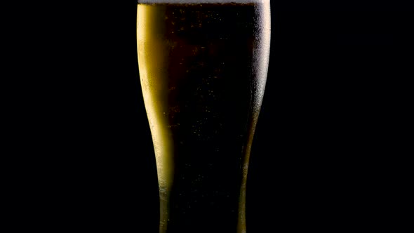 Light Beer In A Beer Glass Appetizing And Fresh On A Black Background Close Up.Draft Beer