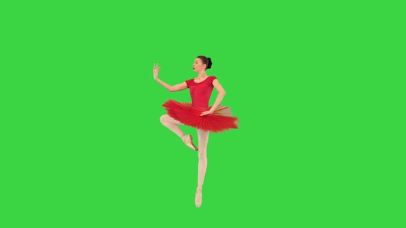 Young Ballerina in Red Ballet Tutu and Pointe Shoes Dancing on a Green Screen Chroma Key
