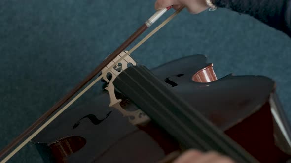 Girl playing cello during lesson