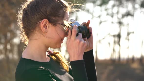 Beautiful Girl Takes Pictures of Her Beloved Man on a Film Camera