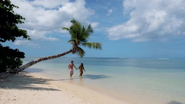 Anse Takamaka Beach Mahe Seychelles Tropical Beach with Palm Trees and a Blue Ocean Couple Man and