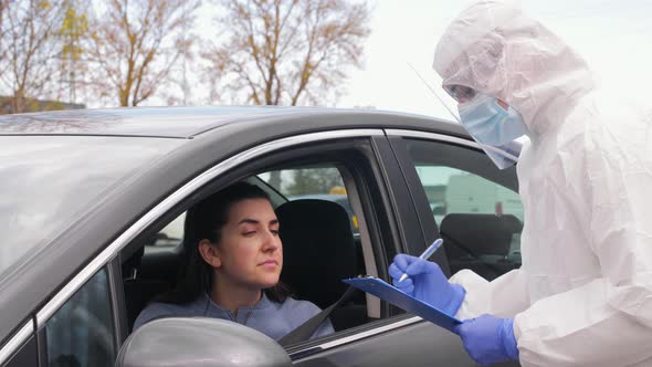 Healthcare Worker with Clipboard and Woman in Car