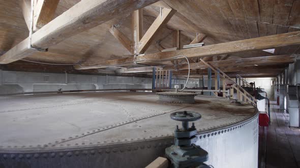 Large Stainless Steel Alcoholic Beverages Distilling Tanks in Old Factory. Silos for Wine and Cognac