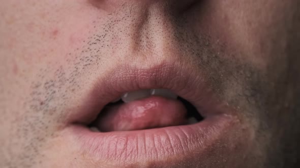 Man Erotically Licks His Lips With His Tongue CloseUp